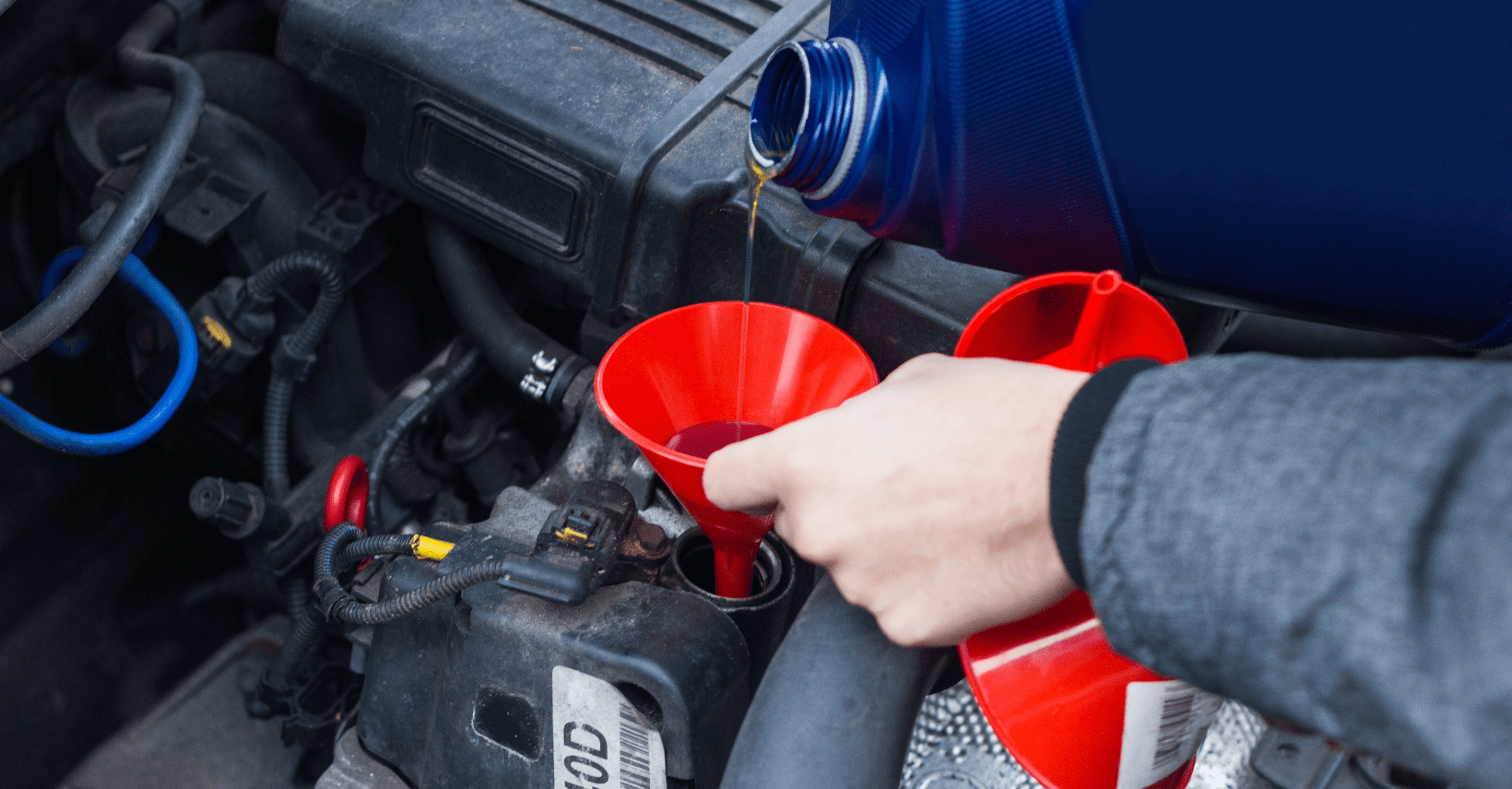 A fleet mechanic performs oil changes for fleet vehicles.