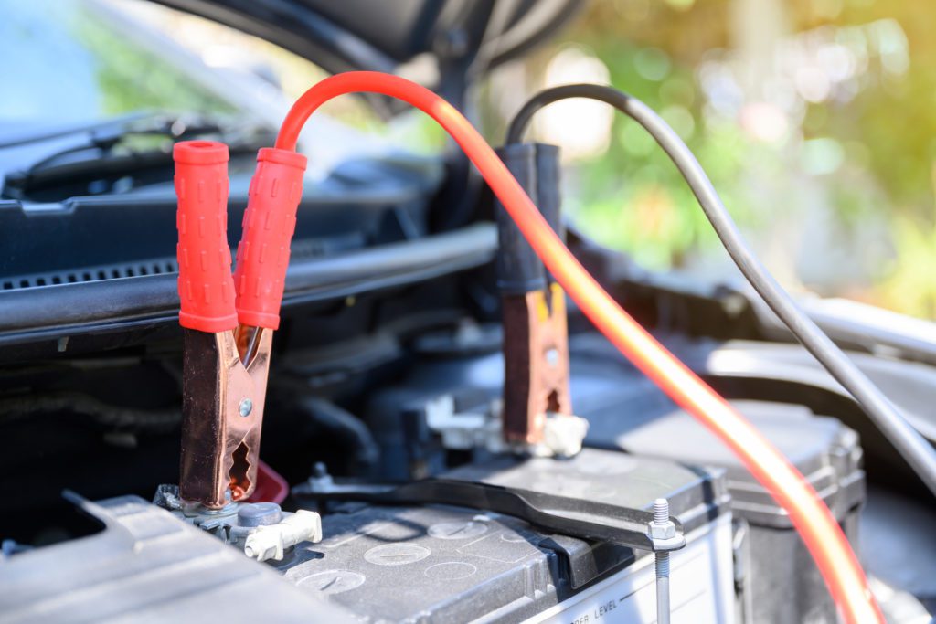 Jumper cables on an engine to charge it can be a sign you need an electrical auto mechanic.