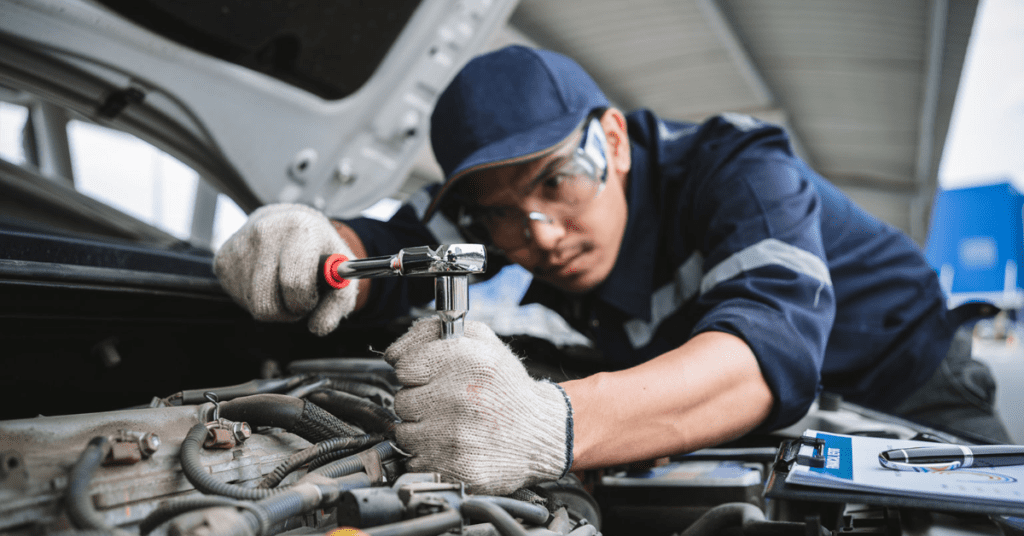 A mechanic at an engine repair shop in Albuquerque performs a routine check on an engine. 