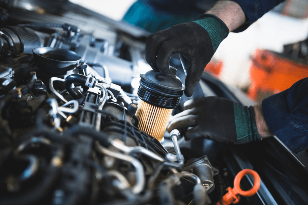 A mechanic skilled in engine repair in Albuquerque changes the filter in an engine. 