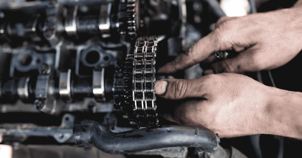 A mechanic repairs an engine.