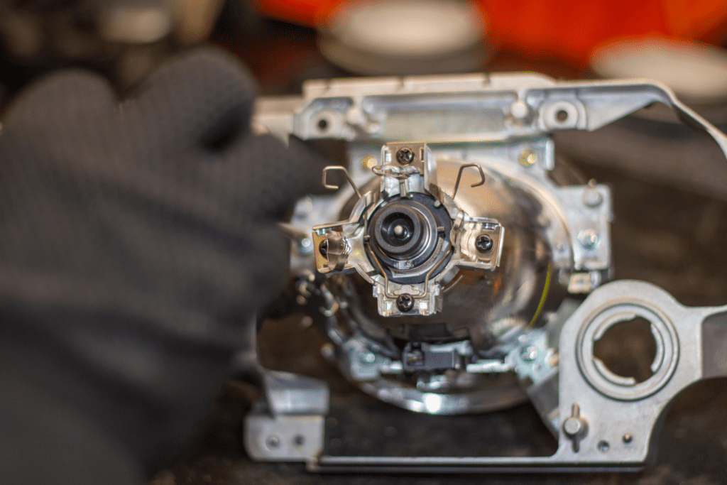 A mechanic examines the solenoid component in a foreign vehicle. 