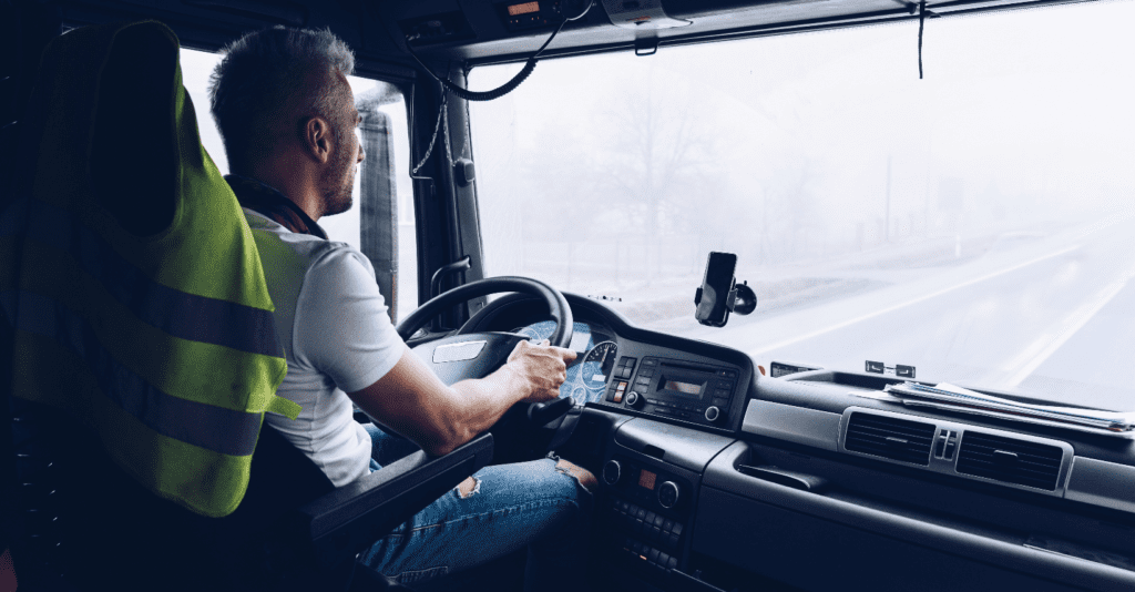 A driver sits behind the wheel of a fleet vehicle. 