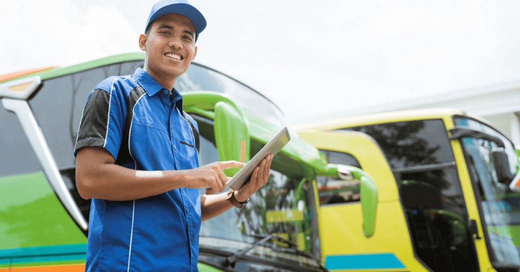 A mechanic inspects fleet vehicles for a company to see if they need oil changes. 