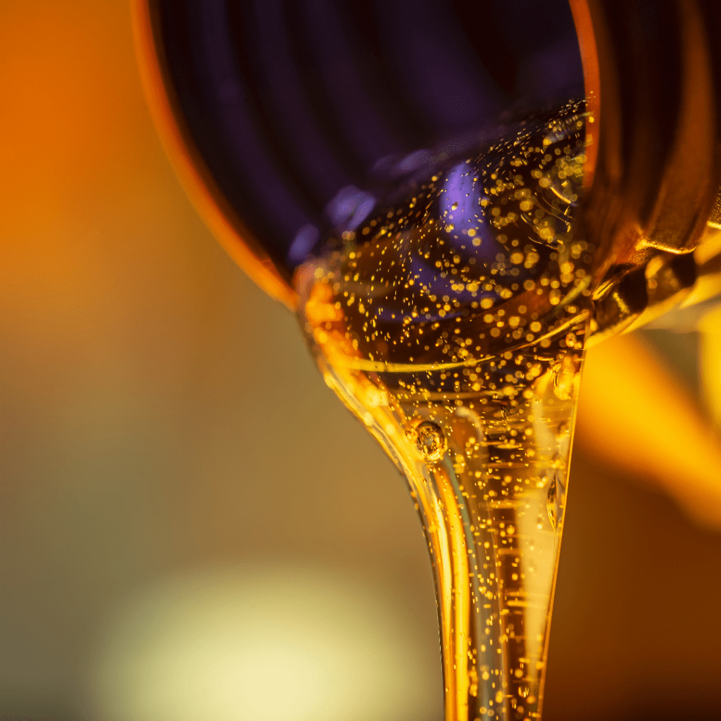 Synthetic oil pours from a container. 