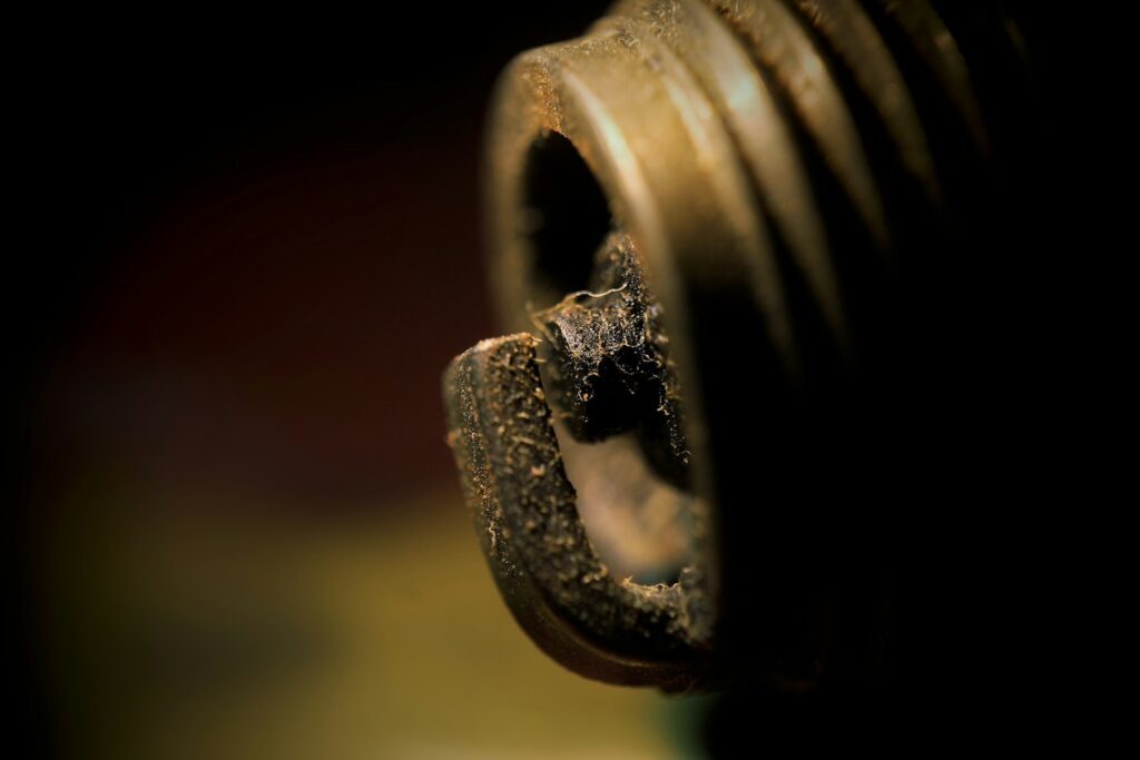 a close up of a metal object with a black background